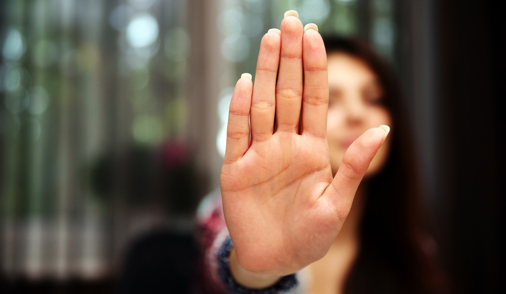 liv-raissi-woman-with-her-hand-extended-signaling-to-stop-only-her-hand-is-in-focus